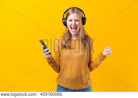 Woman Dancing To Music While Listening To Mp3 Player With Wired Headphones. Energy Move Of Caucasian