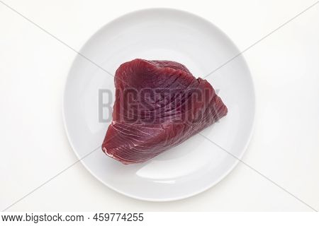 Raw Tuna Meat Cut Out With Fatty Layers On A White Plate With White Background. Top View Closeup Mac