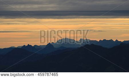 Bright Lit Yellow Morning Sky Over Mount Grosser Mythen, Saentis And Other Mountains In The Swiss Al