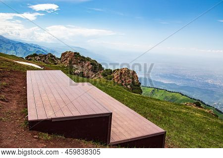 Observation Deck On The Top Of The Mountain For Hikers At The Kok Zhailau Tract And The City Of Alma