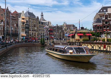 Amsterdam, The Netherlands - 21 June 2022: Tour Boat In Rokin Canal