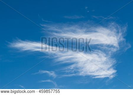 Beautiful Thin Cirrus Clouds. White Spindrift Clouds In A Shape Of An Angel On Blue Sky. Background.
