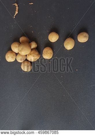 Small Potatoes On A Black Table Background