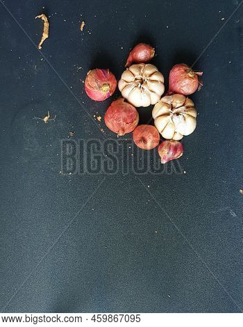 Garlic And Onion On A Black Board.