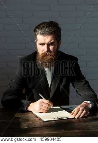 Man Teaching Near Chalkboard In Classroom. Exam In College Or University. Teacher Or Professor At Cl