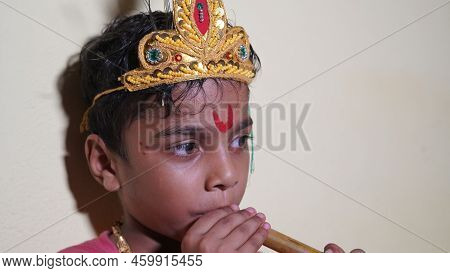 Asian Boy Posing As Shri Krishna Or Kanhaiya On Fancy Dress Or Gokulashtami Festival.