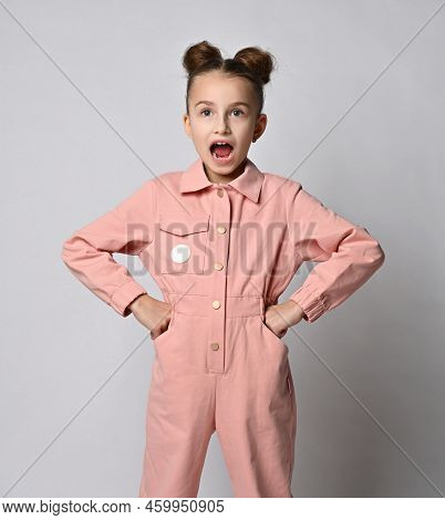 Screaming Girl, In A Pink Cotton Jumpsuit, Put Her Hands On Her Hips And Yells Indignantly At Someon