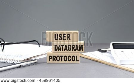 Udp - User Datagram Protocol Text On A Wooden Block With Notebook,chart And Calculator, Grey Backgro