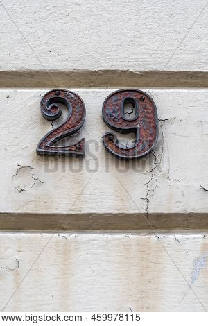 Number Twenty Nine On White Painted Plaster Wall