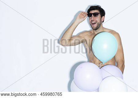 Portrait Of One Funny Laughing Caucasian Handsome Brunet Man With Bunch Of Colorful Air Balloons In