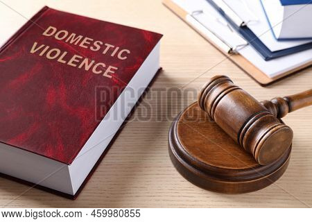 Law Book And Gavel On Wooden Table. Protection From Domestic Violence