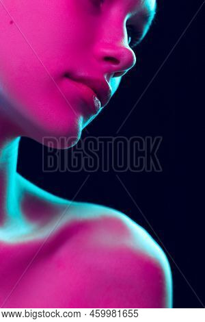 Closeup Female Lips, Cheeks And Nose Isolated Over Dark Background In Neon Light. Concept Of Cosmeto