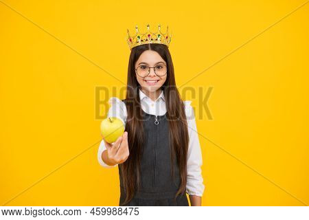 Princess Child In Queen Crown Hold Apple Isolated On Yellow Background. Teenage Girl Wear Diadem. Ha