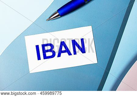 White Blank Card With Iban International Bank Account Number Text And Blue Pen On Blue, Cyan And Pin
