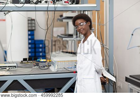 Scientist African American Woman Working In Laboratory With Electronic Tech Single Photon Detector. 