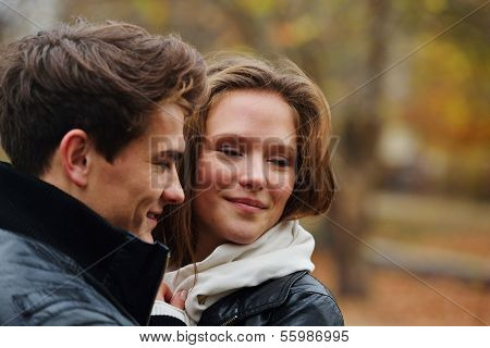 Lovely couple enjoying fall in love at park