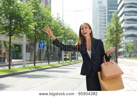 Businesswoman With Raised Arm Calling For Taxing