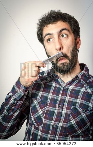 young man want comb his beard and moustaches