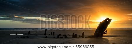 Landscape Panorama Ship Wreck On Rhosilli Bay Beach In Wales At Sunset