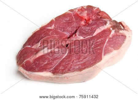 Raw boneless lamb leg steak on white background.