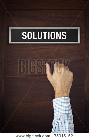 Hand Is Knocking On Solutions Bureau Door