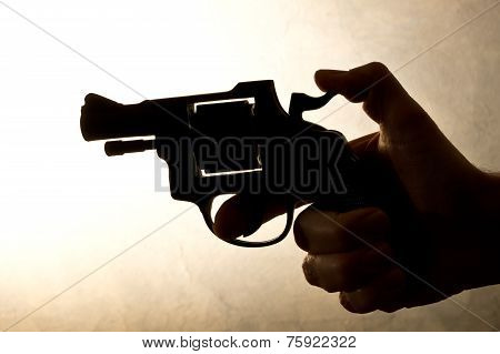 Silhouette Of A Mans Hand With A Handgun