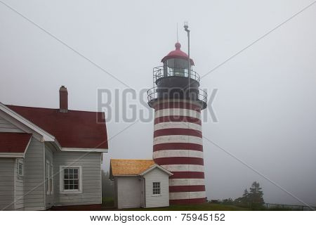 LUBEC-JULY 10: West Quody lighthouse in fogy day in Maine, USA on July 10, 2013.