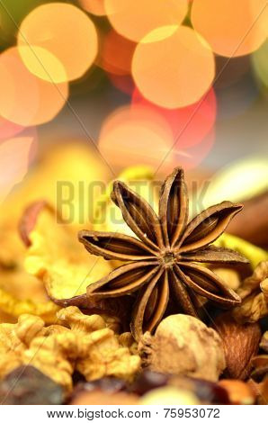 christmas spices, nuts, cookies and dried fruits on bokeh background