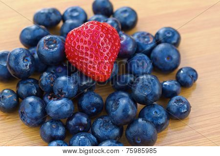 Bunch of bluberries and strawberry on a table