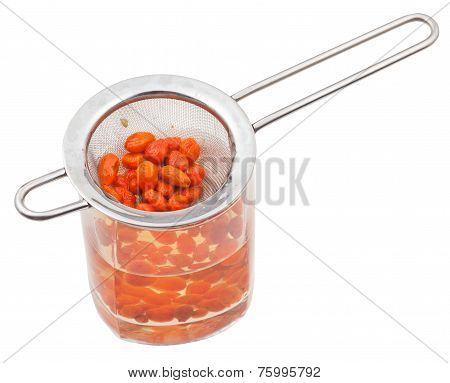 Strainer And Glass With Goji Berries Infusion