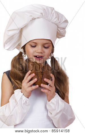 Cooking and people concept - smiling little girl in cook hat, isolated on white background
