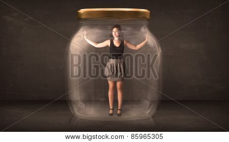 Businesswoman captured in a glass jar concept concept on background