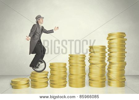 Business man riding monocycle up on coin graph concept on background