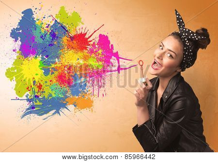Cute girl blowing bubble spalsh graffiti into wall