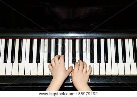 Girl's Hands And Piano Keyboard Close-up View