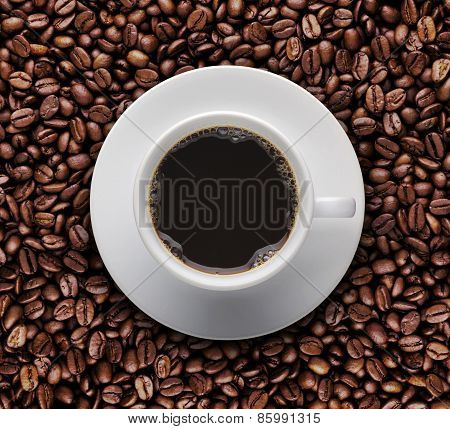 Hot Coffee Cup On Roast Coffee Beans. Top View