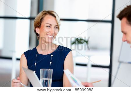Businesswoman doing a presentaion in front of her collegues