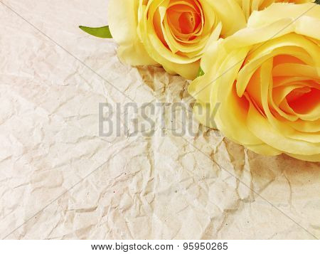 beautiful roses flower on paper texture background with filters color and space for copy