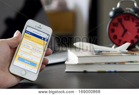 Bangkok, Thailand - December 5, 2016: Business man using Booking.com to book hotel for his business trip.