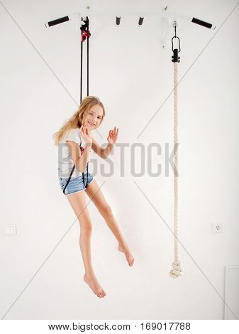 Girl on the wall bars. Child at wall bars do sport exercises