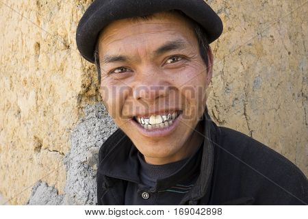 Ha Giang, Vietnam - Feb 7, 2014: Portrait of a Hmong man smiling at tourist. The Hmong are an Asian ethnic group from the mountainous regions of China, Vietnam, Laos, and Thailand