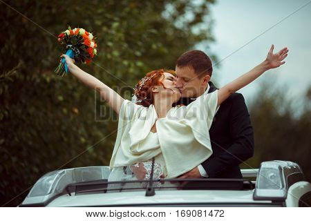 Groom Hugs Bride From Behind Standing In An Open Hatchway