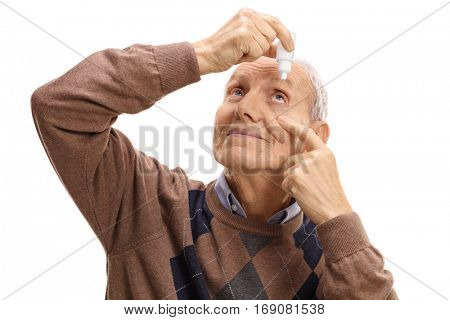 Mature man applying eye drops isolated on white background