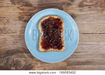 Typical Dutch apple syrup called Appelstroop on bread on wooden background