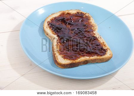 Typical Dutch apple syrup called Appelstroop on bread on wooden background