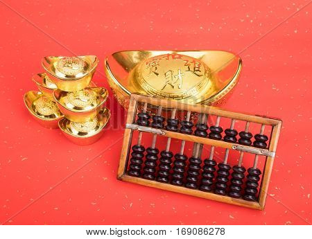 Chinese gold ingot and abacus mean symbols of wealth and prosperity.