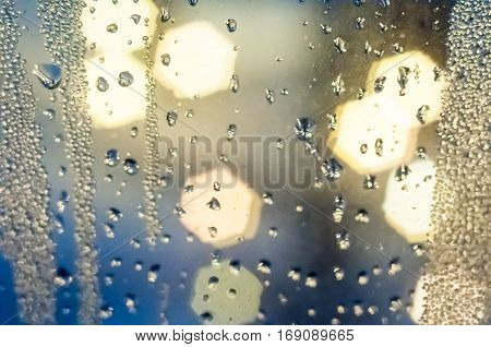 Condenced water drops on a blurred background with lights