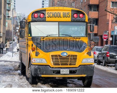 Toronto, Canada - December 21, 2016: Blue Bird Vision school bus waiting for service in a residential part of downtown Toronto, Ontario, Canada