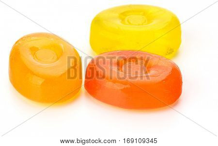 Three colorful fruit hard sugar candies,  boiled sweeties or sugar plums isolated on white background cutout