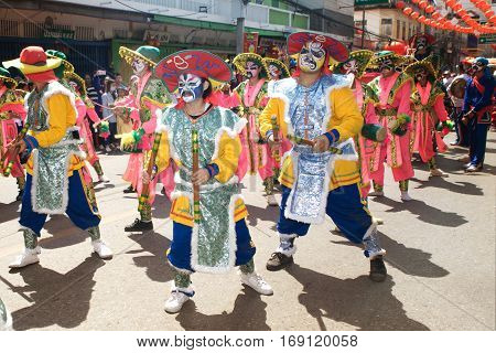NAKHONSAWAN ,THAILAND - JANUARY 31,2017 : Unidentified fighting show of villager warriors ( Aung-Gor ) on the street in city during the Chinese New Year celebrations in Nakhonsawan Province,Middle of Thailand.